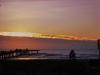 Plataforma e pôr-do-sol na praia de Tramandaí