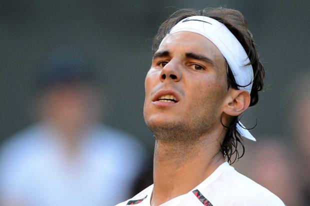 Com novo problema, Nadal está fora do Aberto da Austrália AFP PHOTO / MIGUEL MEDINA/ Com novo problema, Nadal está fora do Aberto da Austrália AFP PHOTO / MIGUEL MEDINA/